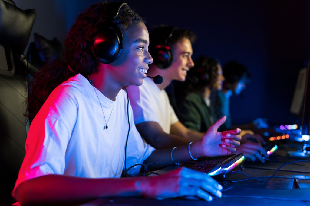Teens playing in video game club